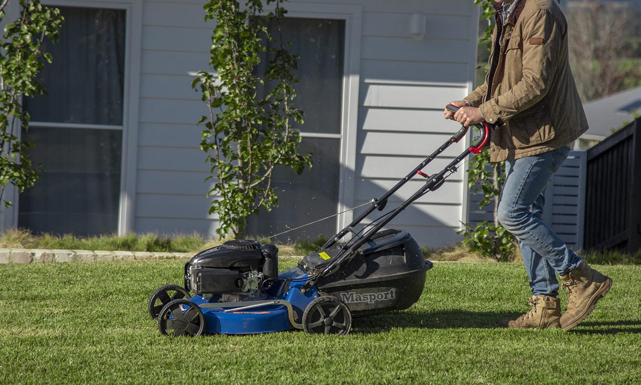 A person maintaining their lawn